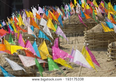 Sonkran festival ,religion flag pinned on sand pagoda in temple.