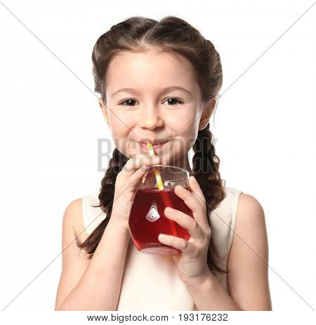 Cute little girl drinking juice on white background