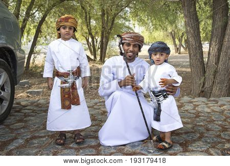 Nizwa Oman - June 26th 2017: omani family dressed for Eid al Fitr day that is celebrated at the end of Holy month of Ramadan