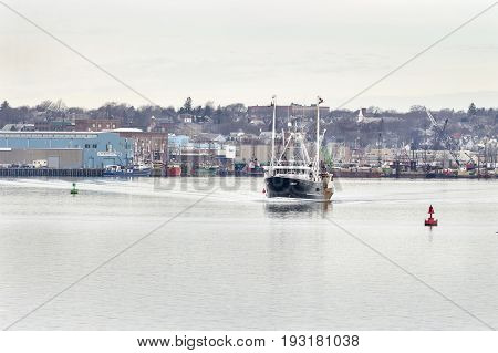New Bedford Massachusetts USA - January 2 2017: Fishing trawler heading toward Buzzards Bay from New Bedford inner harbor