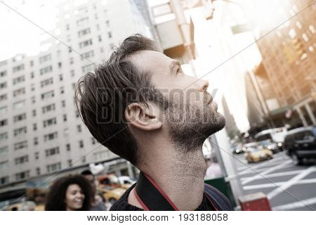 Portrait of man looking at New York city skyscrappers