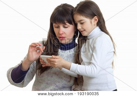 couple of pother and daughter looking a photos on a mobile phone isolated on white background