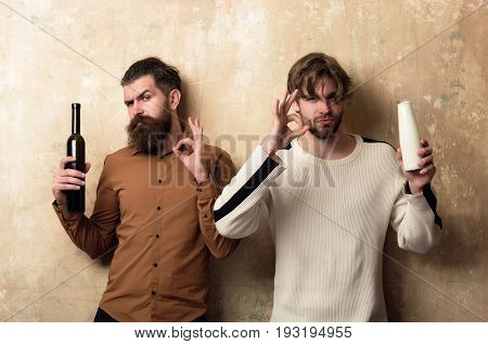 Friends Showing Ok Gestures With Bottles