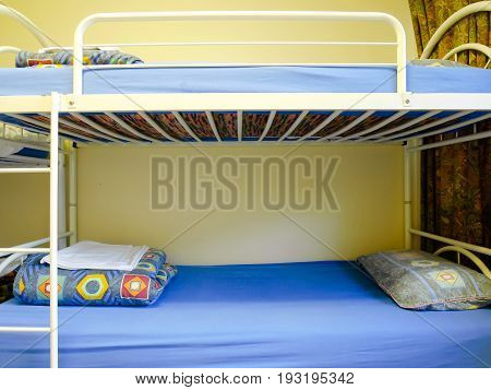 Bunk beds with pillows and blankets at the hostel