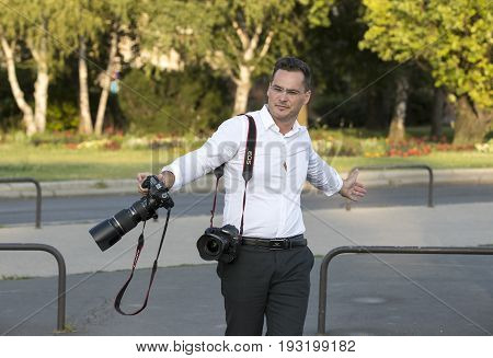 BUDAPEST, HUNGARY. 23 JUNE, 2017: A group of wedding photographers on the streets of Budapest is holding a photo session for a couple of newlyweds.