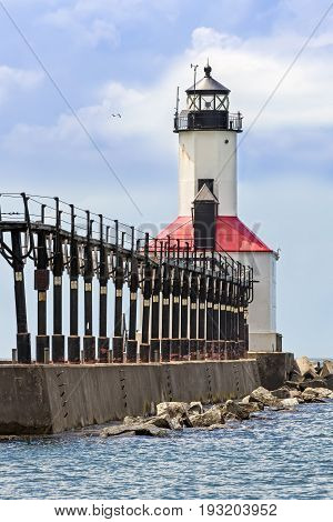 An elevated catwalk leads to the historic East Pierhead Lighthouse on Lake Michigan at Michigan City Indiana.