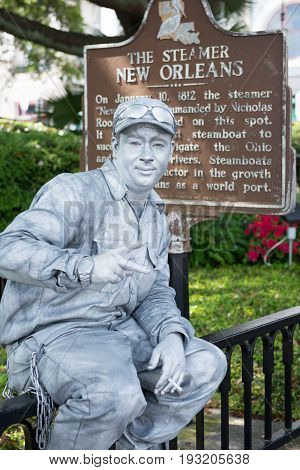NEW ORLEANS, LA - APRIL 13: View of a Street actor dressed up as a tin man in front of the Steamer historical sign on April 13, 2014