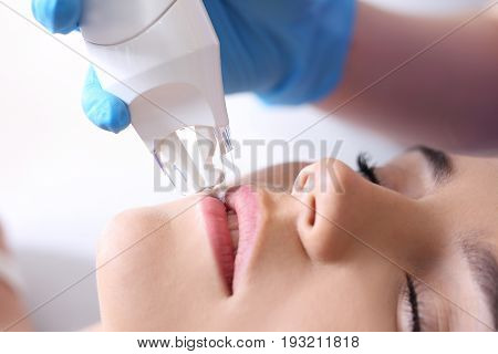 A vacuum facial massage using a special head. Woman in the clinic of aesthetic medicine.