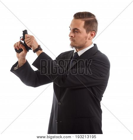 A man in a suit reloading a handgun