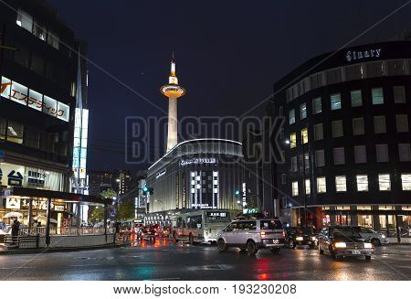 KYOTO JAPAN - November 18 2015: Evening traffic intersection near Yodobashi camera department store and overlooking Kyoto Tower