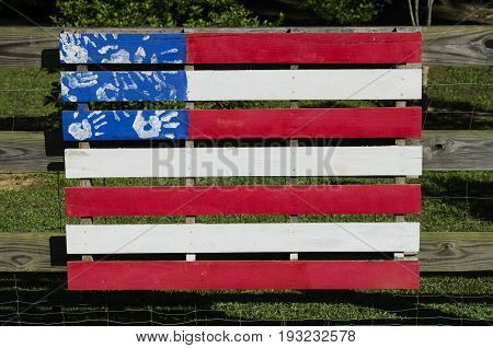 Painted fense section colored like the American Flag