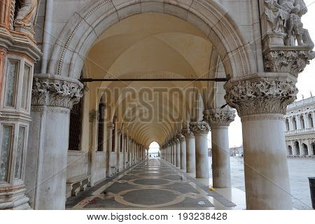A row of arches underneath the Doge's Palace, San Marco in Venice Italy