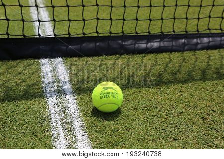 NEW YORK - JUNE 29, 2017: Slazenger Wimbledon Tennis Ball on grass tennis court. Slazenger Wimbledon Tennis Ball exclusively used and endorsed by The Championships, Wimbledon