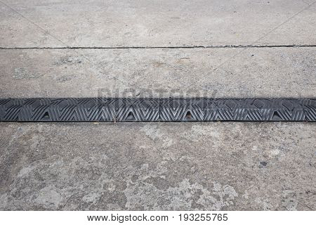 Old Black Rubber Speed Bumper Humps on the road.
