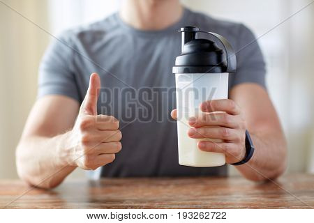 sport, fitness, healthy lifestyle, diet and people concept - close up of man with food rich in protein showing thumbs up