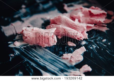 Ice cream roll fried in the fridge freezer pan on the street in Thailand fresh cooking made from fresh strawberries milk blueberries. Concept of tourist delicacy.