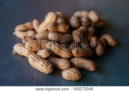 Peanut in shell texture and background. Peanuts texture. Shelled Peanuts. Healthy food. Close up view of shelled peanuts in wooden background. Abstract background and texture for designers.