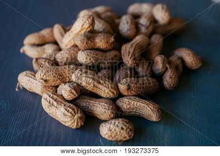 Peanut in shell texture and background. Peanuts texture. Shelled Peanuts. Healthy food. Close up view of shelled peanuts in wooden background. Abstract background and texture for designers.
