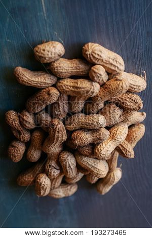 Peanut in shell texture and background. Peanuts texture. Shelled Peanuts. Healthy food. Close up view of shelled peanuts in wooden background. Abstract background and texture for designers.