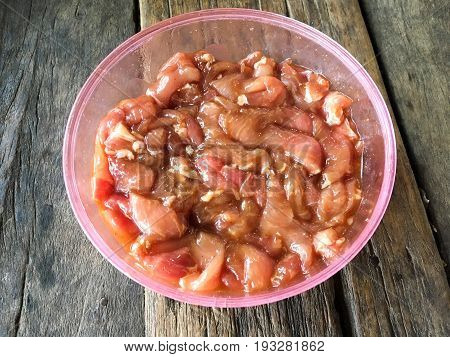 close up Marinated pork on wood floor