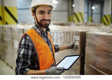 Successful warehouse staff sorting packed goods