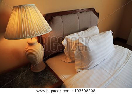 Night scene image of comfortable pillows and bed.