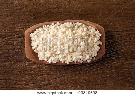 White Grated Corn Kernels In Wooden Bowl. Canjica / Mungunza