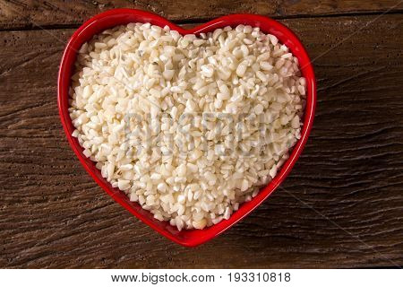 White Grated Corn Kernels In Wooden Bowl. Canjica / Mungunza