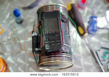 Homemade bomb with a cellphone timer, on a blurred background.