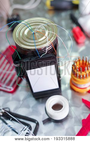 Close up of an improvised homemade bomb explosive device in blurred background.