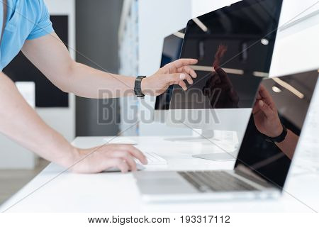 It looks amazing. Shot of a male customer using a mockup personal computer while choosing a new gadget and shopping at a department store.