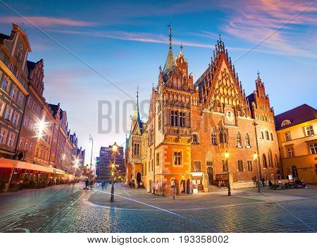 Colorful Evening Scene On Wroclaw Market Square With Town Hall.