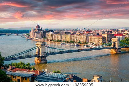 Colorful Cityscape Of Hungarian Parliament Building With Famous Chain Bridge On The Danube River.