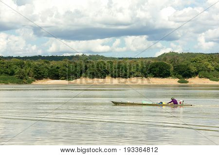 Fisherman In A Long Tailed Boat At The Mekong River