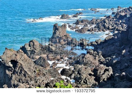 Black volcanic rocck along the beach in St. Kitts