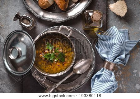 Greek chickpea soup in the pot on the stone background top view horizontal