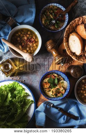 Chickpea soup  Revithia and vegetable stew Briam on the stone background top view vertical