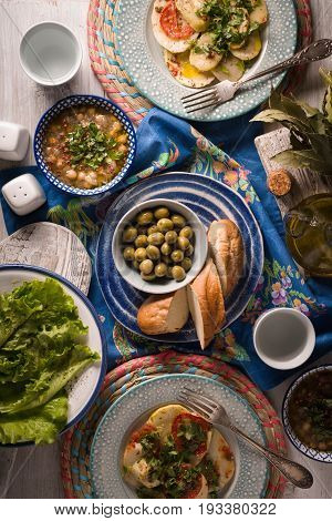 Chickpea soup  Revithia and vegetable stew Briam on the white table top view vertical