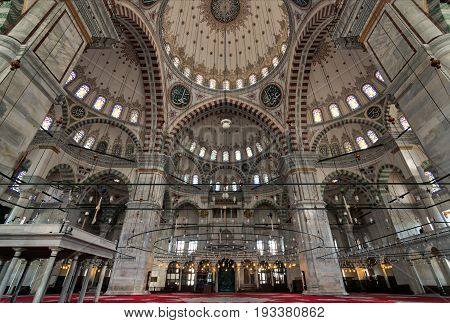 Istanbul, Turkey - April 25, 2017: Fatih Mosque, a public Ottoman mosque in the Fatih district of Istanbul, Turkey, with a huge decorated domes & many colored stained glass windows