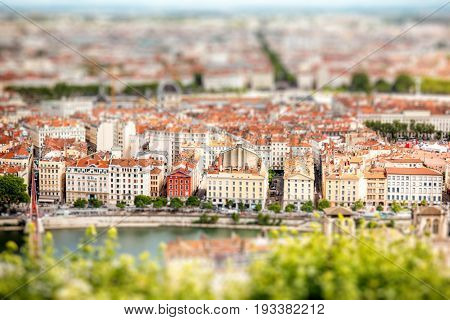 Aerial cityscape view with beautiful old buildings and Rhone river in Lyon city. Tilt-shift image technic