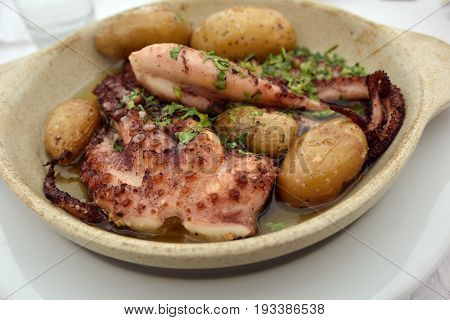 Grilled octopus with batatas a murro or smashed potatoes and garlic in olive oil is a traditional Portuguese dishes