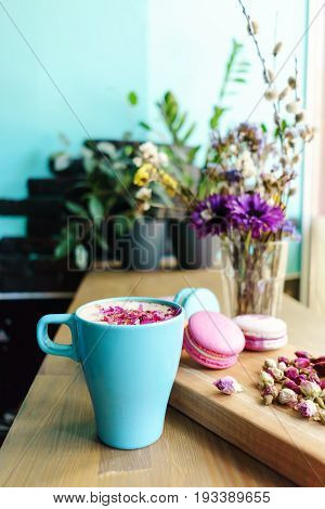 Cup Of Coffee, Tasty Cake And Beautiful Bouquet Of Flowers In Cafe