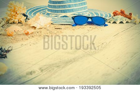 Sand and shells and hat on the wooden floor summer concept travel Seychely beach Florida Hawai swimm in Bali summer pradise