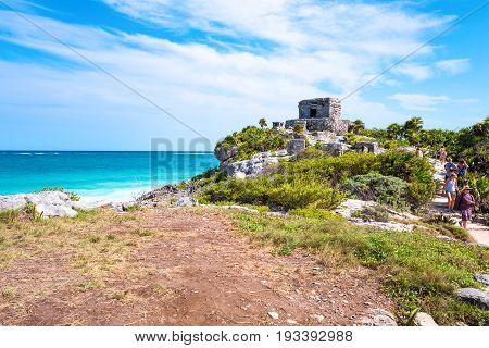 Tulum Mexico - April 20 2016: Sea view from the Mayan city archaeological site with tourists on the right