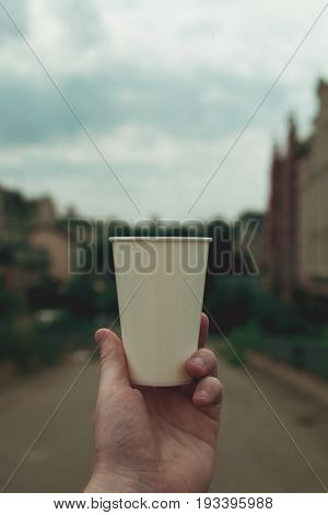 Paper cup on a background of urban landscapes.