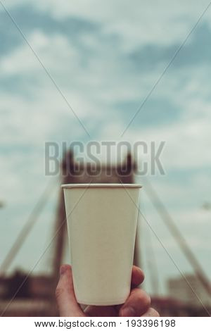 Paper cup on a background of urban landscapes.
