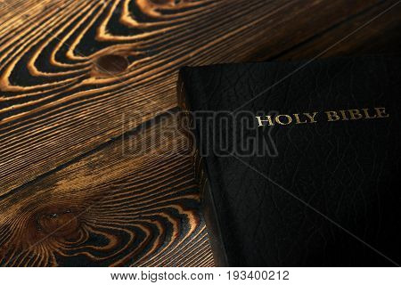 Holy Bible on old wooden church table top view