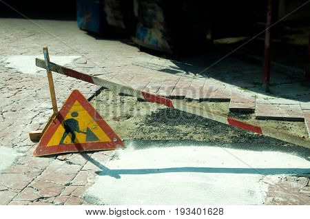 Work ahead road sign on the pavement walkway.