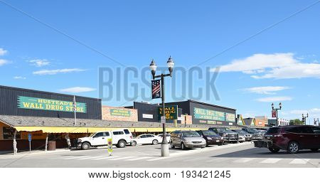 WALL, SOUTH DAKOTA - JUNE 22, 2017: Main Street with Shops. The busy tourist attraction, Wall Drug, and other shops on a typical summer day.