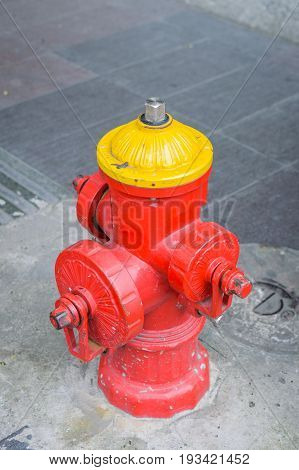 Brightly Colored Fire Hydrant - Photograph of a fire hydrant painted bright yellow and red